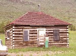 Ann at the little log schoolhouse.